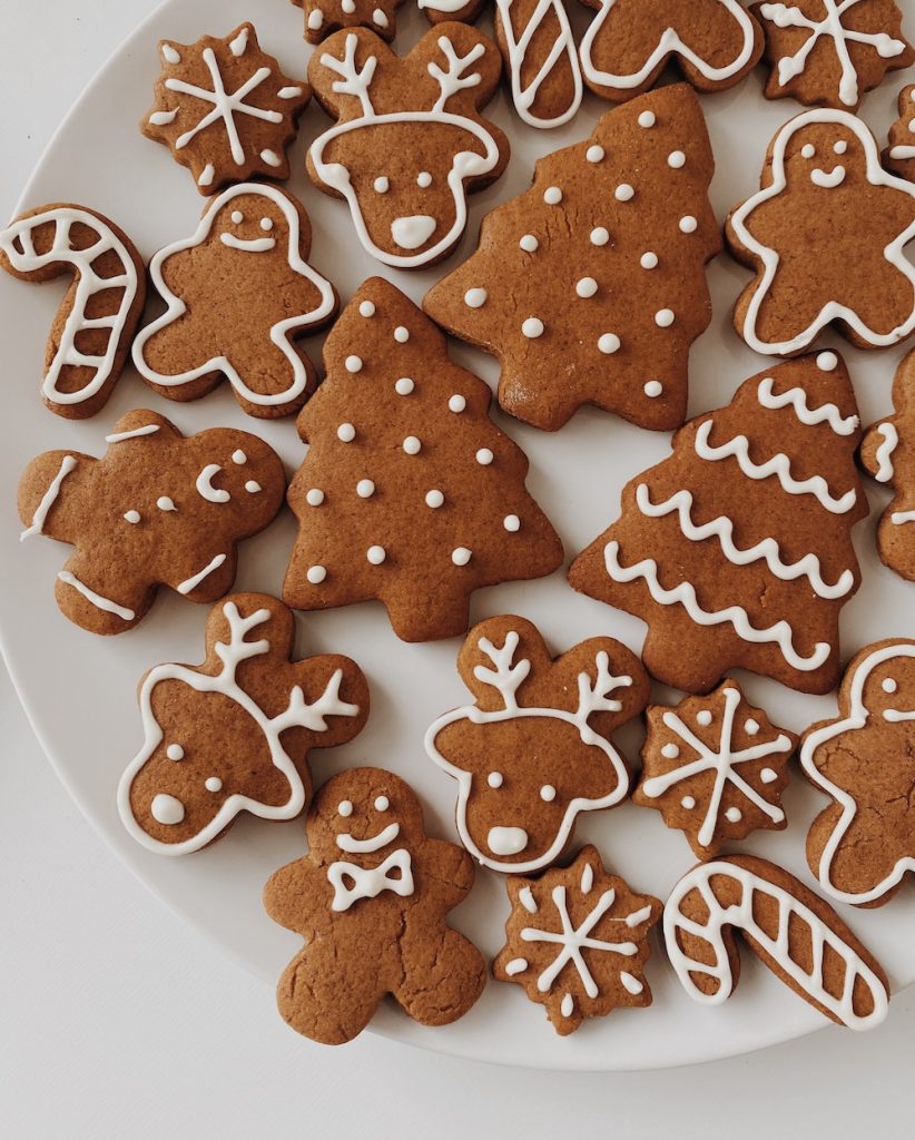 Gingerbread cookies shaped as reindeer, trees, gingerbread men on a plate