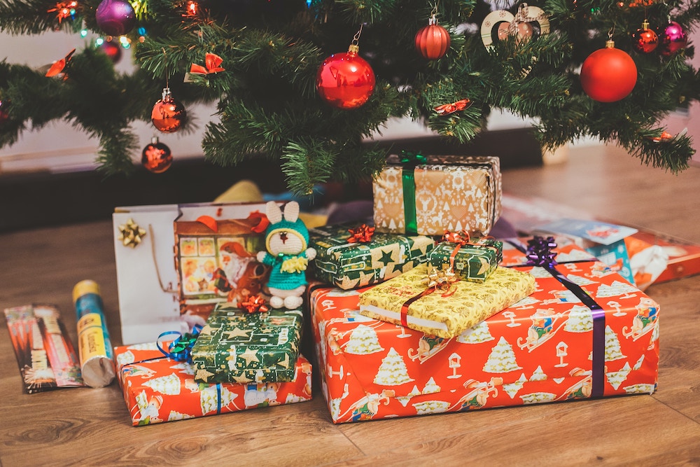 Numerous wrapped presents under a Christmas tree