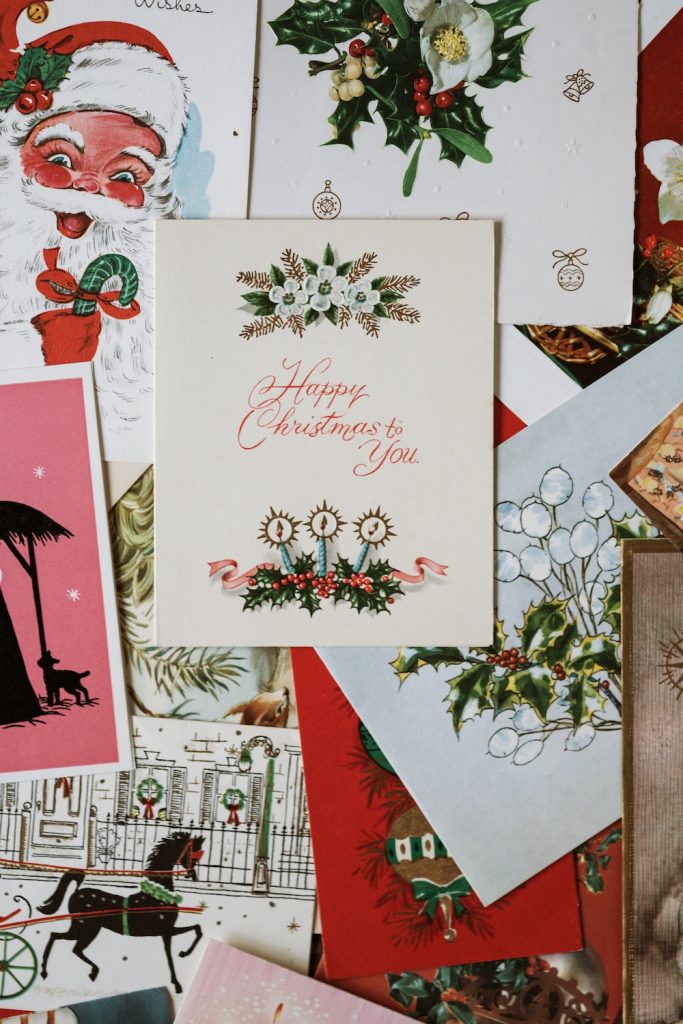 Numerous vintage Christmas cards on tablel