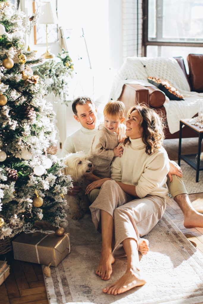 Christmas photo with family, mom, dad, boy, dog in beige colors to show uniform dress.