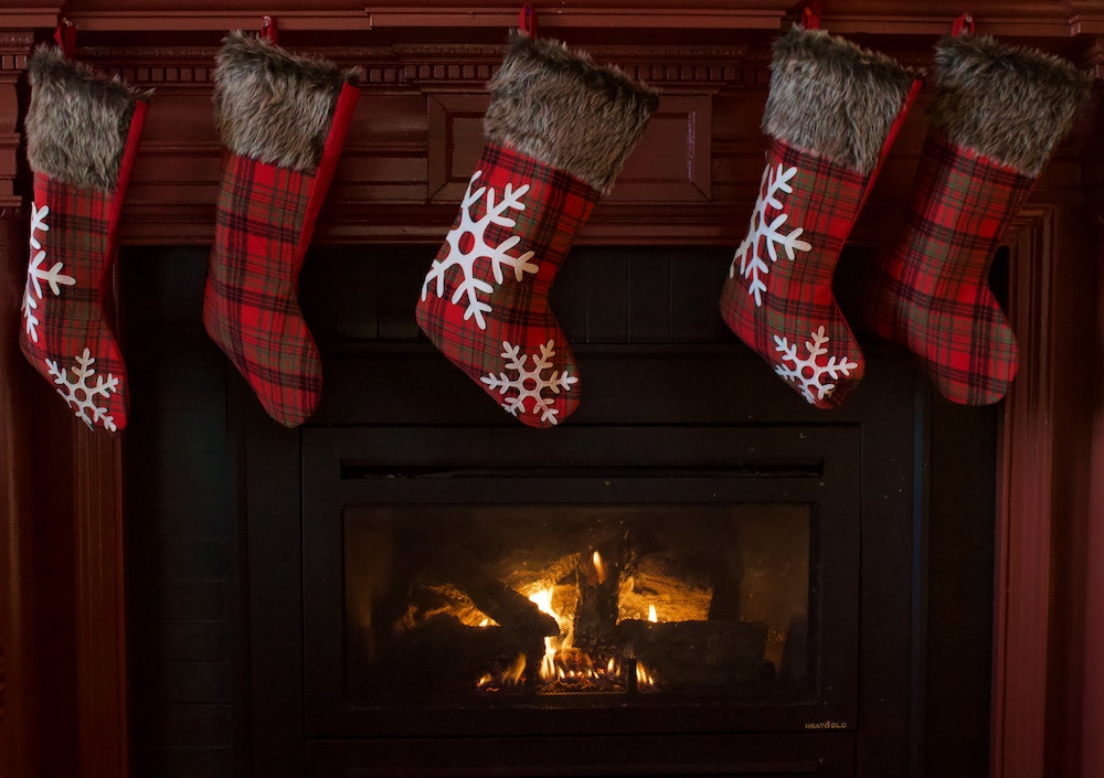 Red plaid stockings hanging on fireplace mantel