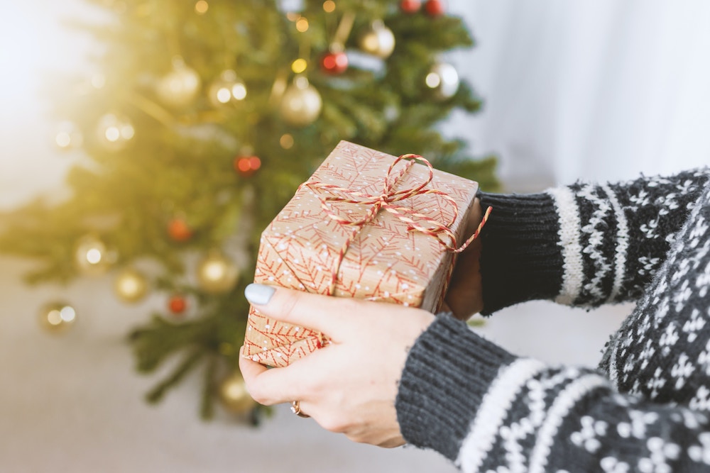 Woman offering a wrapped gift