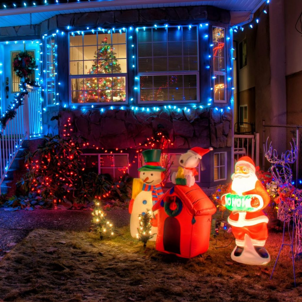 Decorated house with blue Christmas lights, Santa, snowman, 
Snoopy.