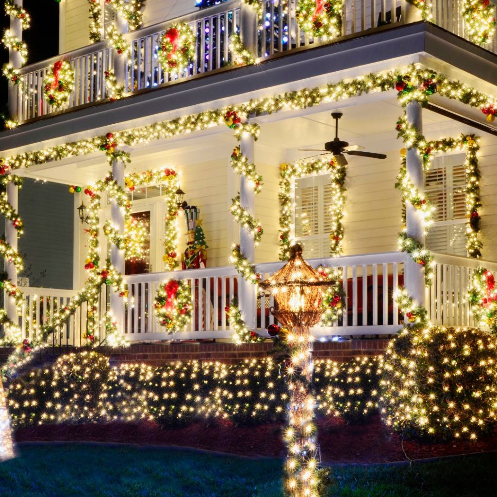 House decorated with outdoor 
Christmas lights mostly white with red bows.