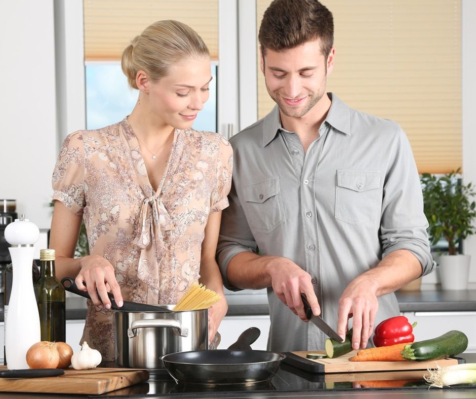 Couple enjoying winter activity cooking together.