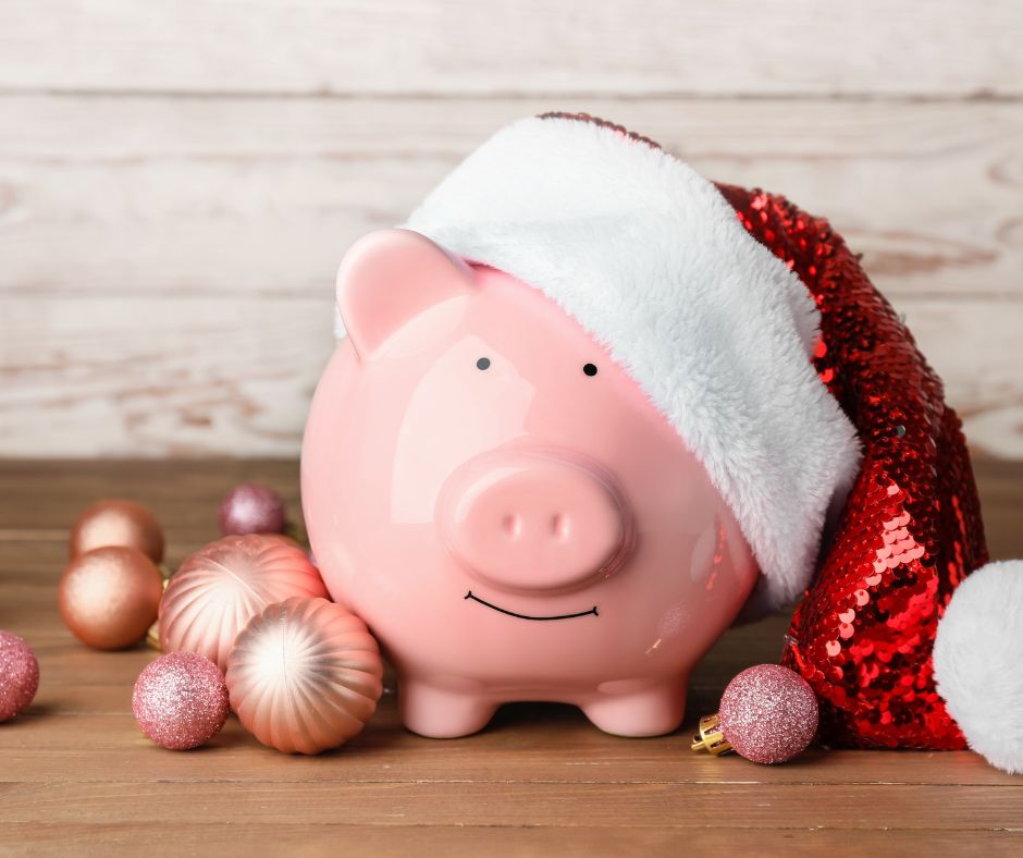 Piggy bank with Santa hat and Christmas ornaments to depict importance of Christmas savings. 
