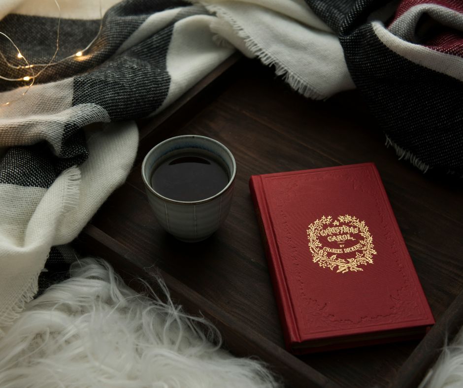 Christmas book A Christmas Carol with cup of coffee and scarf