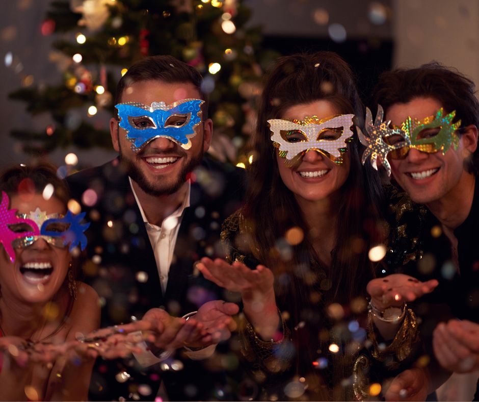 Four people with masks to show one of Christmas party themes.