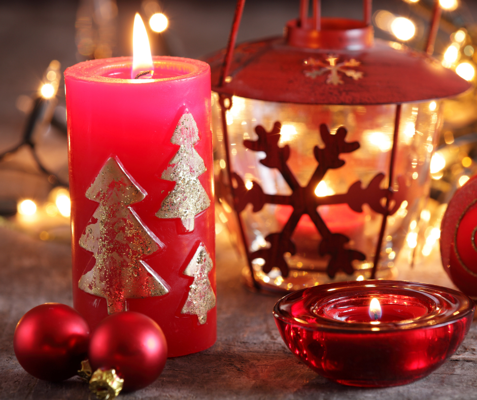 Various red candles with red ornaments. 